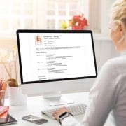 A person working on a computer learning more about client references