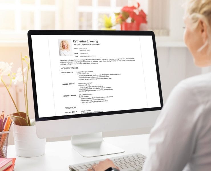 A person working on a computer learning more about client references